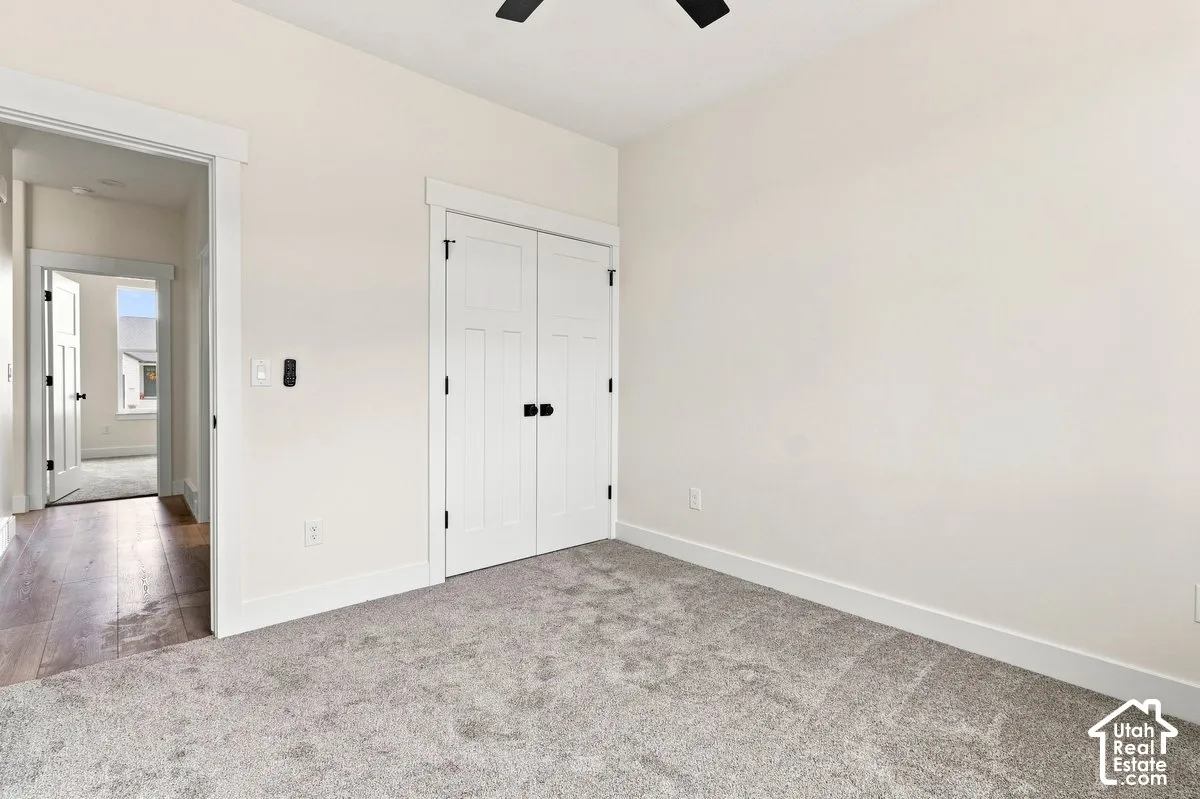 Neutral-toned walls complement the light gray carpeting
