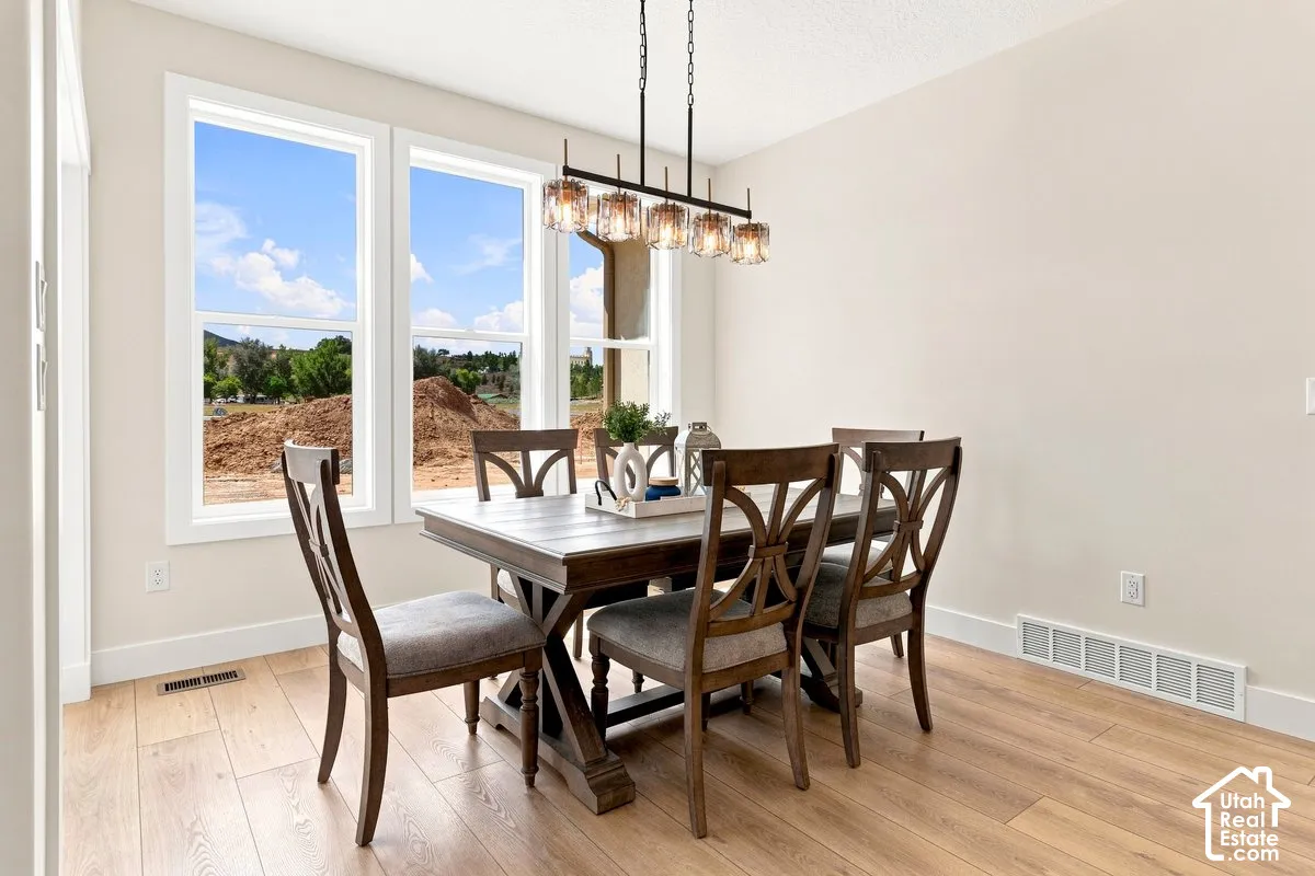 Light wood-finish flooring with white baseboards