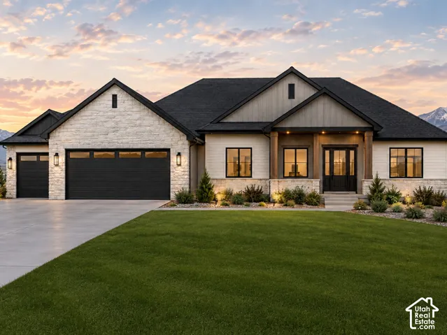 Exterior featuring stone and siding finishes, a dual-door entry, a covered porch with wood-wrapped columns, a two-car garage, and established landscaping