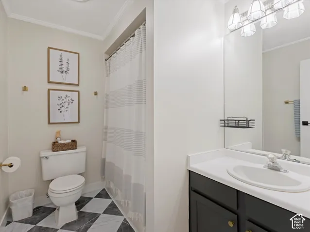 Black and white checkered floor, modern vanity with white countertop, integrated sink, and wall-mounted mirror