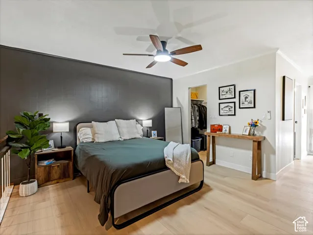 Light wood-finish flooring throughout, complemented by a contemporary ceiling fan with integrated lighting
