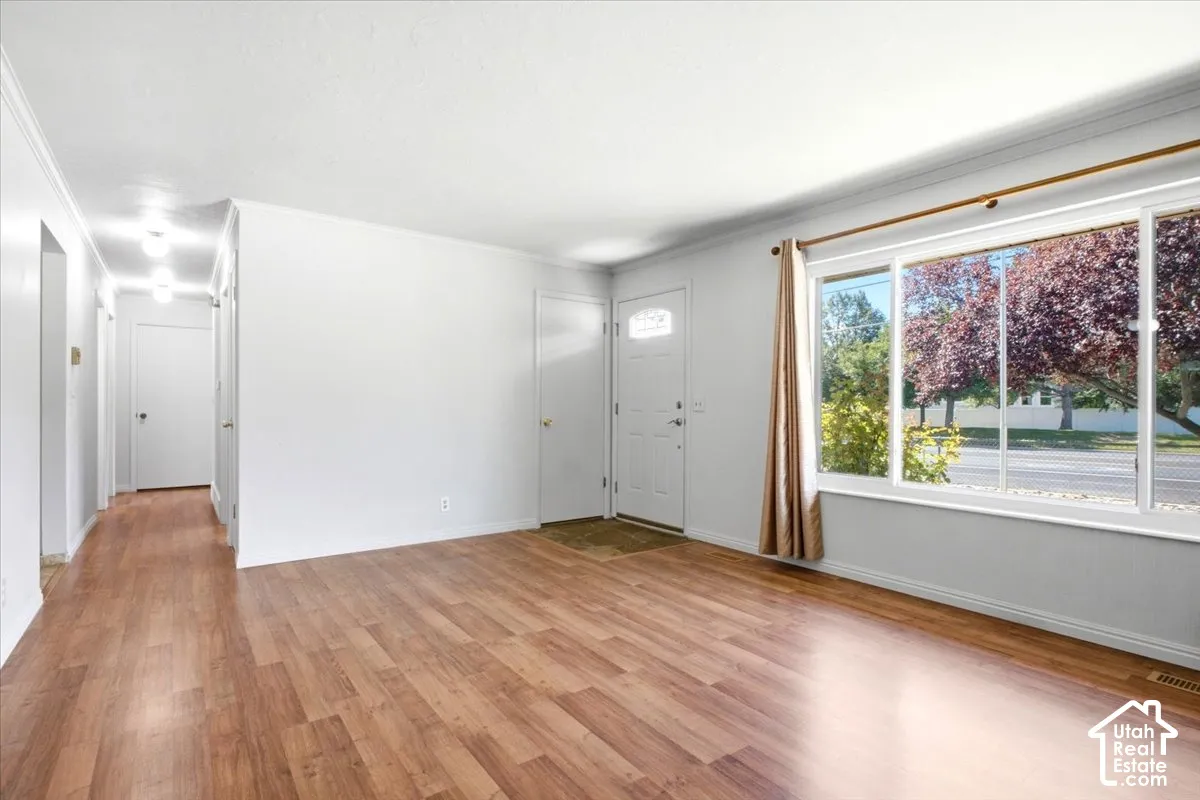 Wood-finish flooring throughout the main living area and hallway