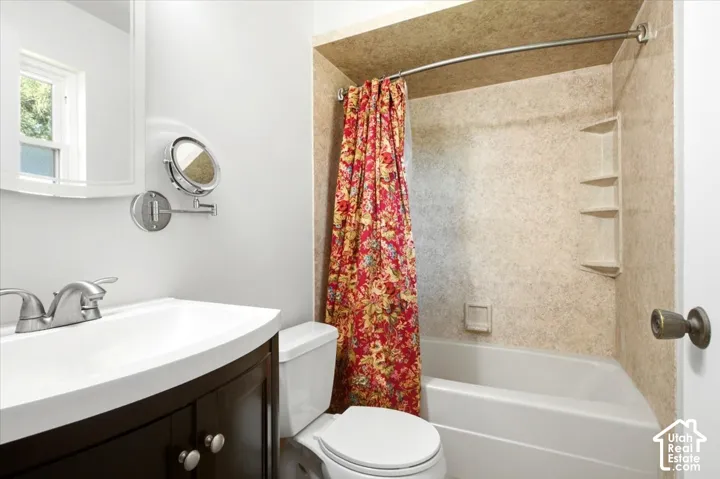Master Bathroom featuring a dark wood-finish vanity, integrated sink, and brushed nickel fixtures
