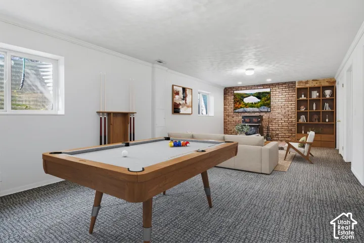 Recessed lighting illuminates a brick-clad wall, complemented by built-in shelving