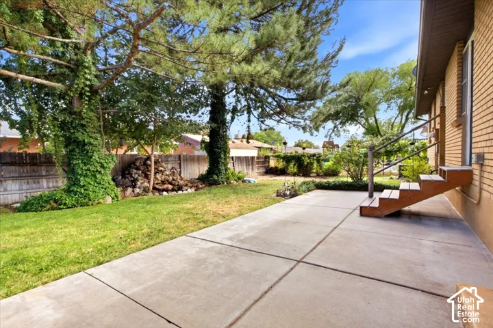 Expansive concrete patio with direct access to the brick exterior