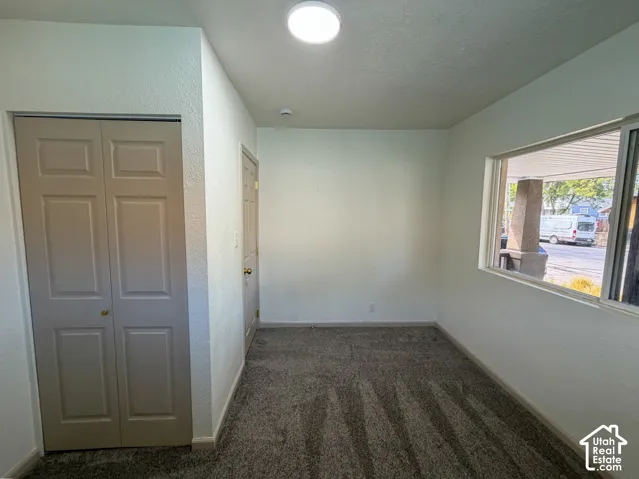 Neutral-toned walls complement the textured carpet flooring