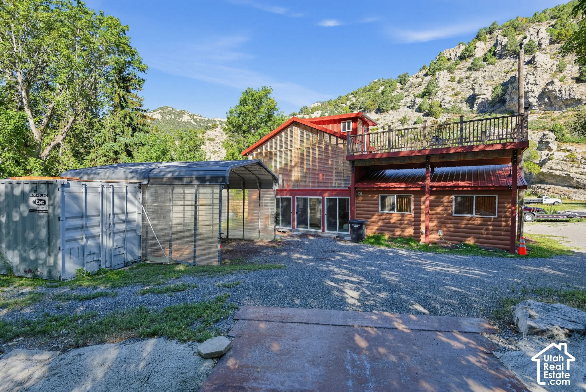 Log cabin-style lower level with a metal roof