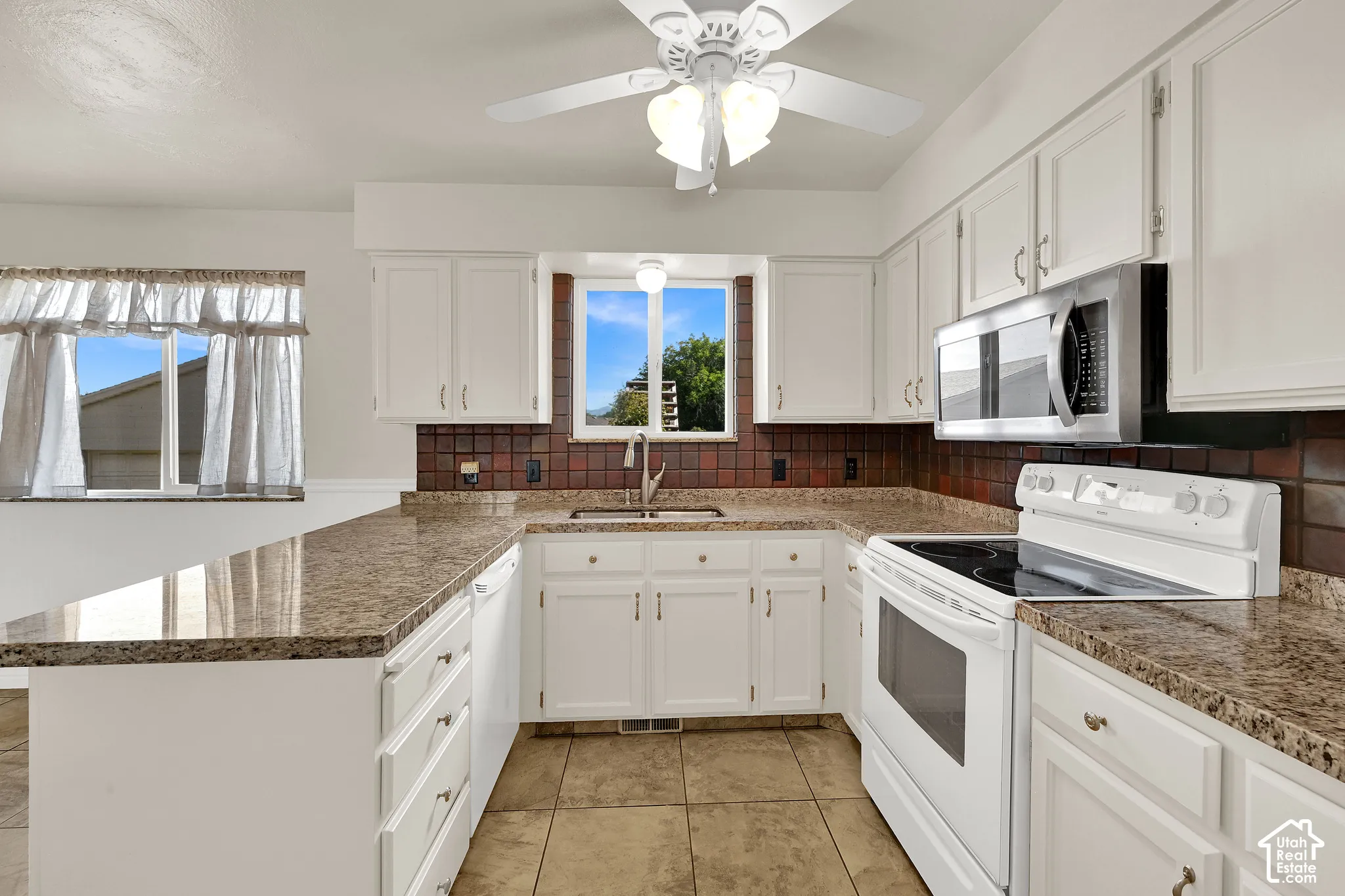 Spacious kitchen looks out to the backyard and has plenty of workspace