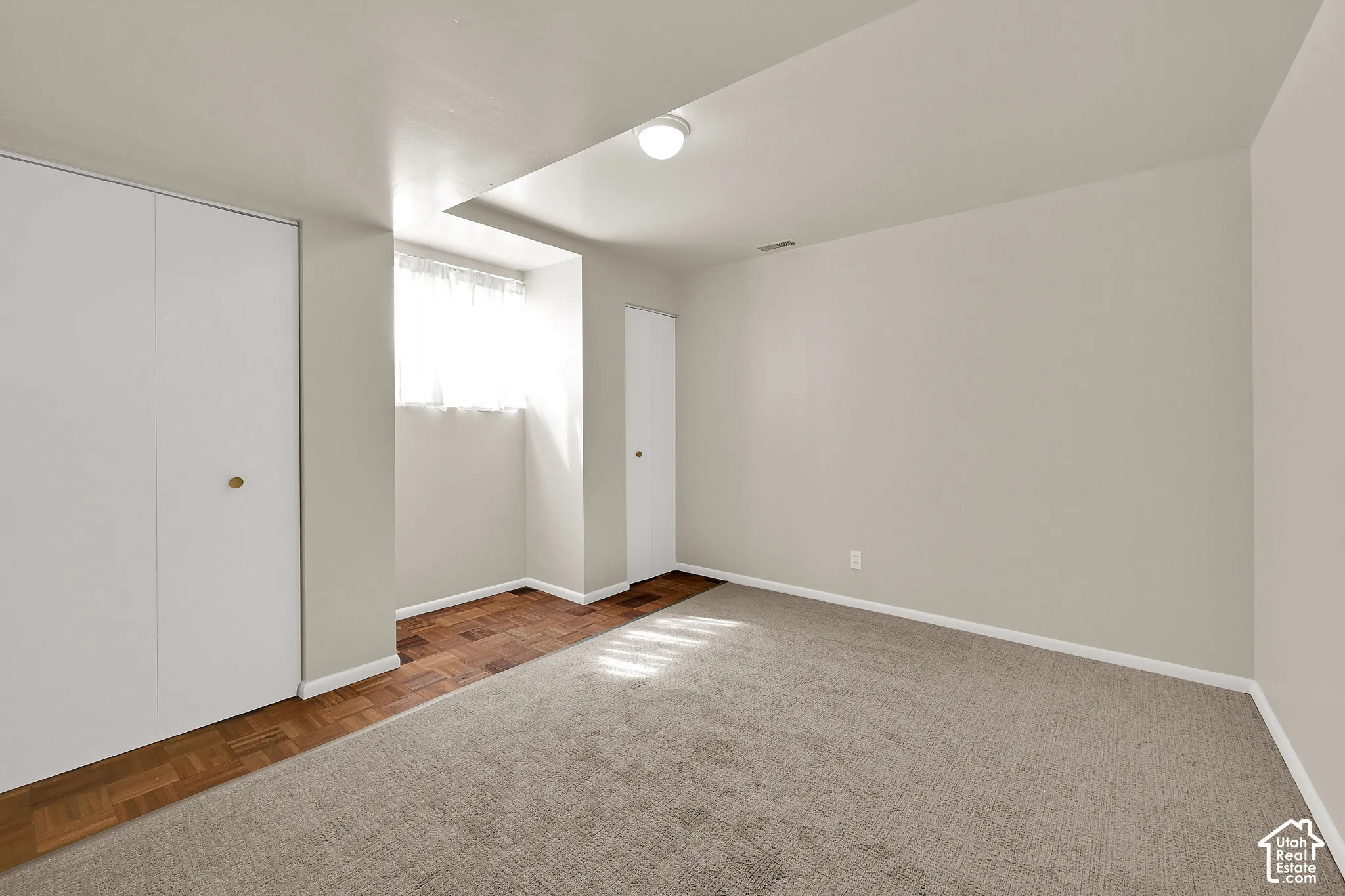 Downstairs bedroom with fresh carpet and paint
