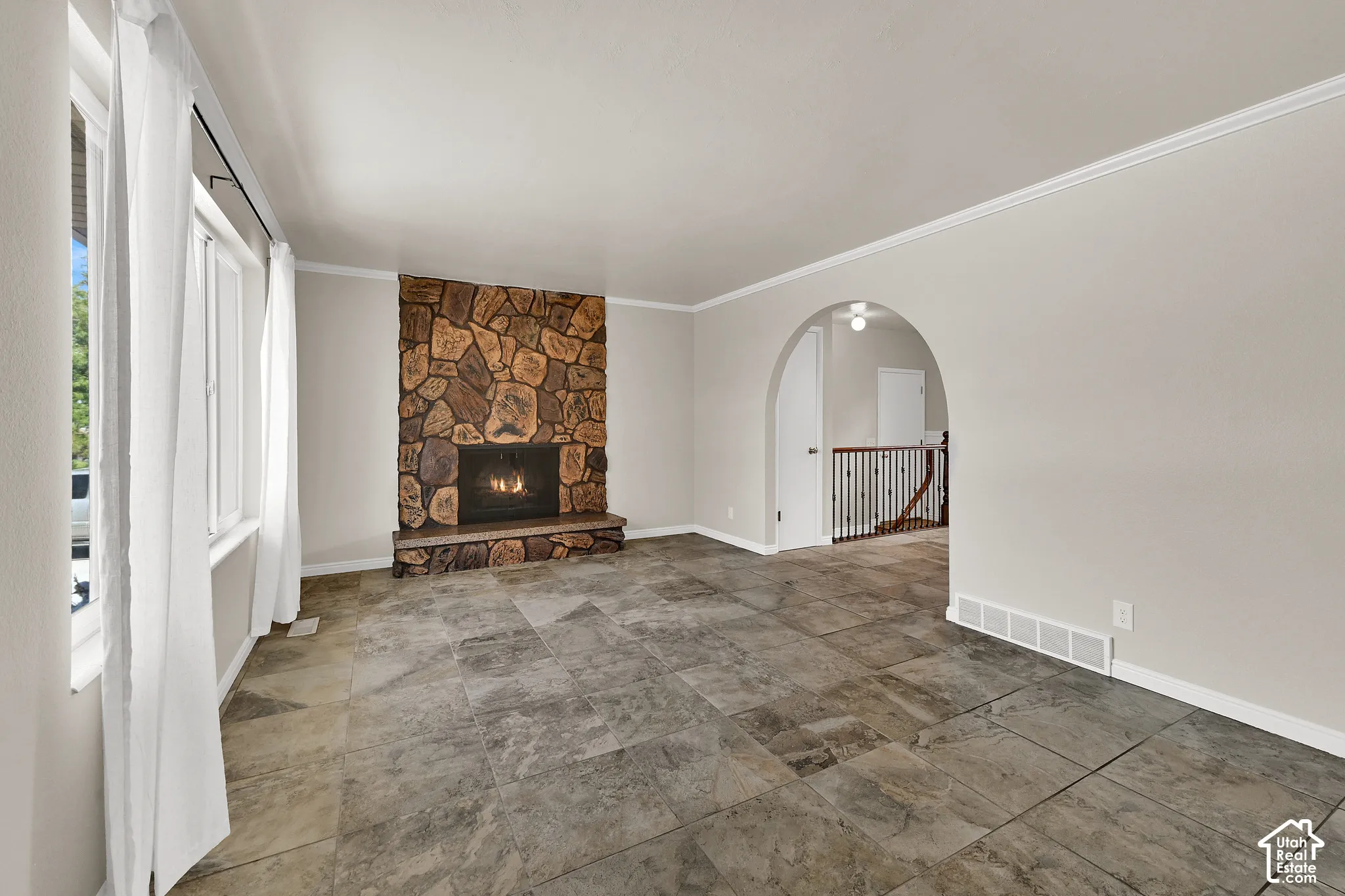 Living Room with tile flooring and a wood burning fireplace.