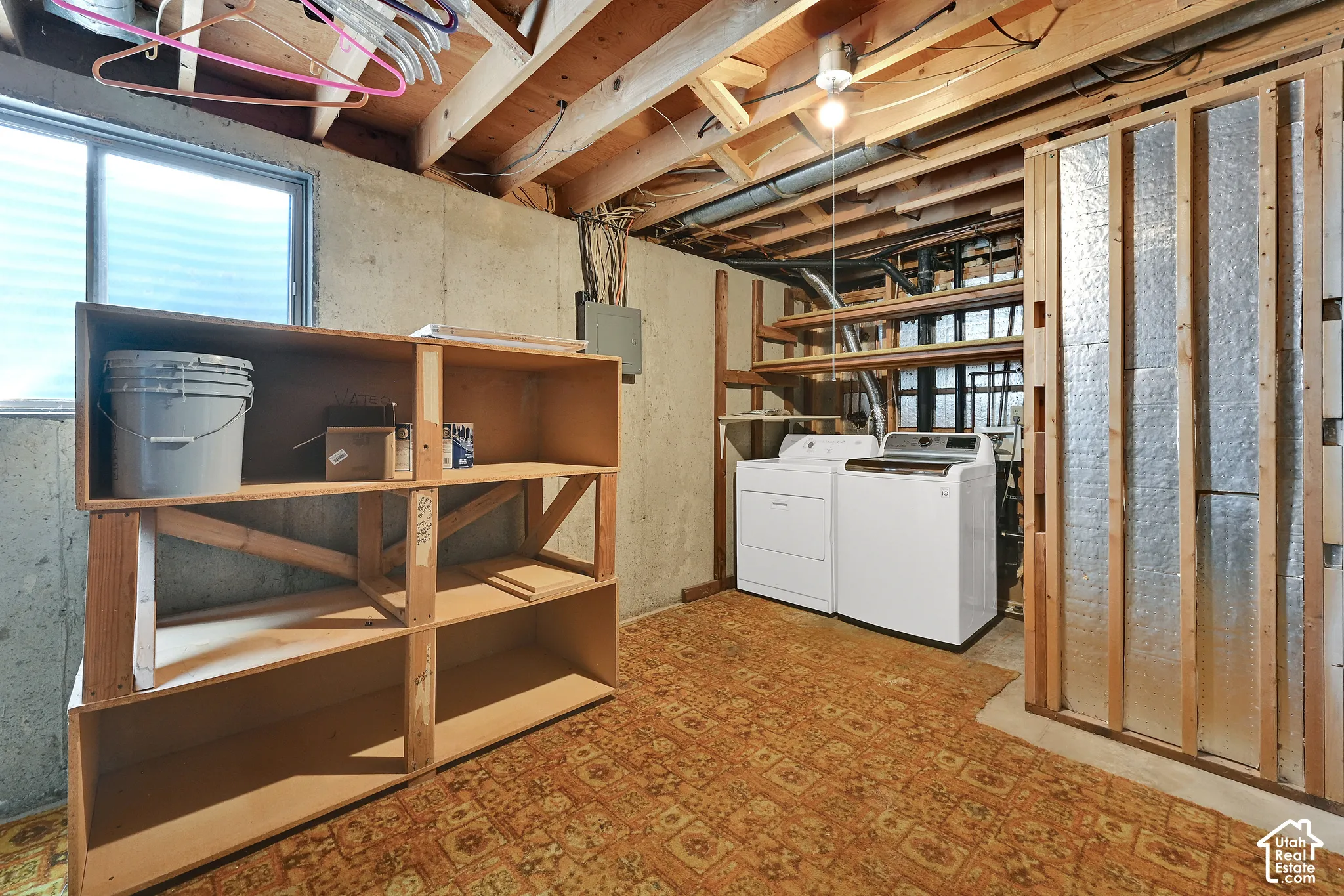Huge Laundry area with tons of storage space and storage shelves- shelving units stay