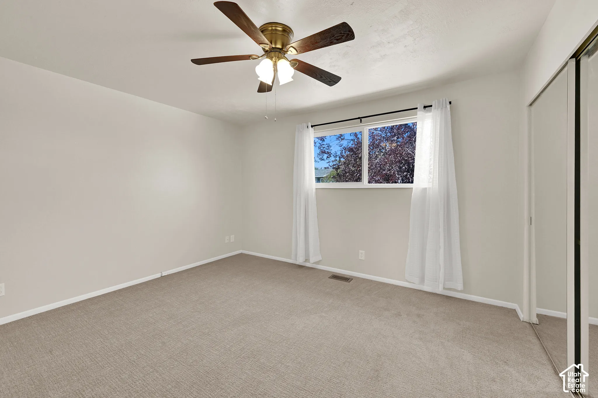 Spacious bedroom with fresh carpet and paint
