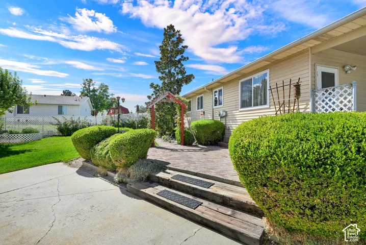Spacious patio area with manicured lawn and garden