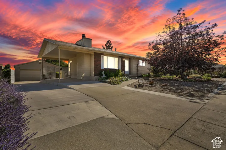 Beautiful home with xeriscaped front yard, carport and  a detached garage