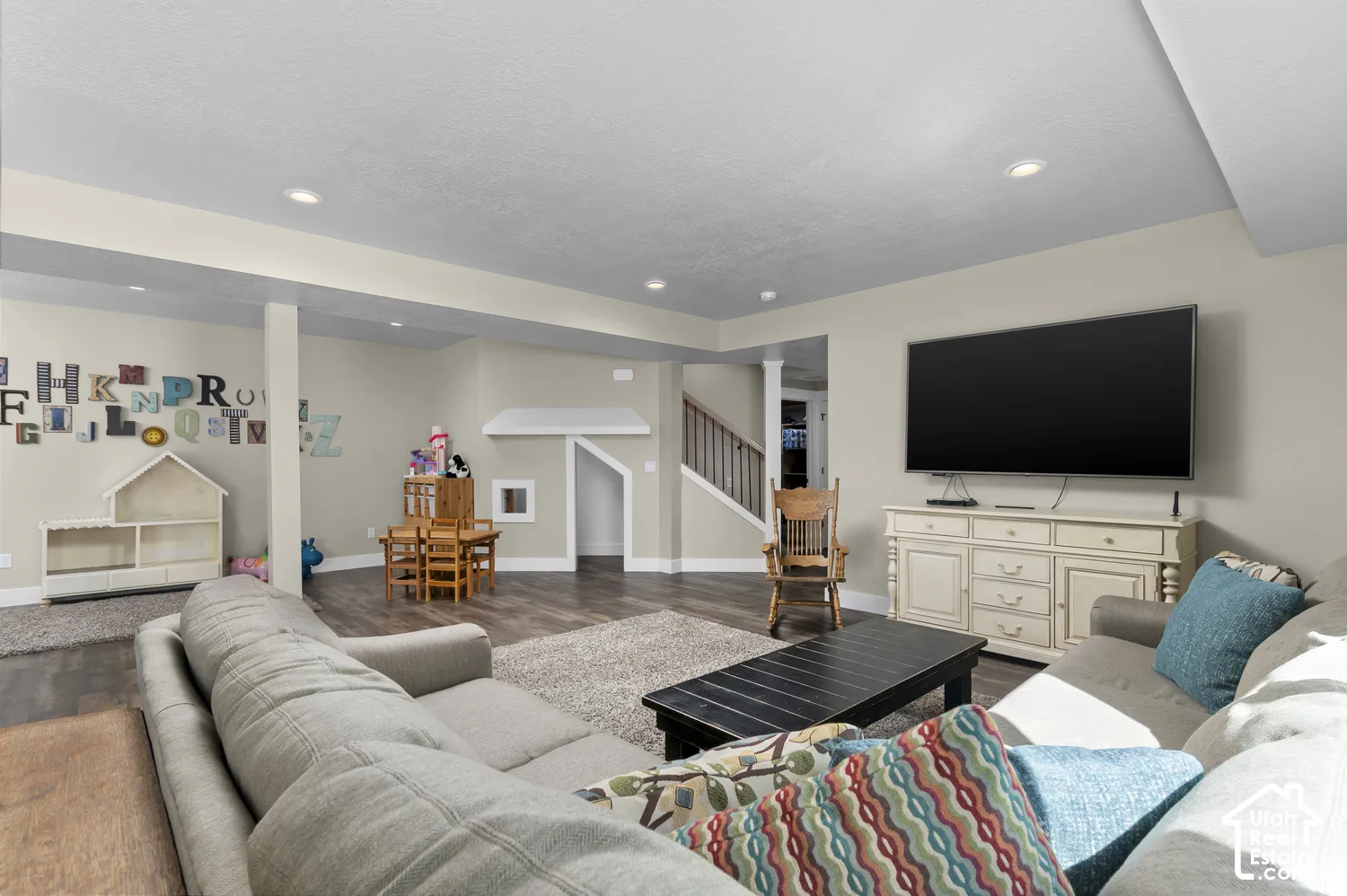 Spacious room featuring recessed lighting, wood-finish flooring, and a built-in play structure