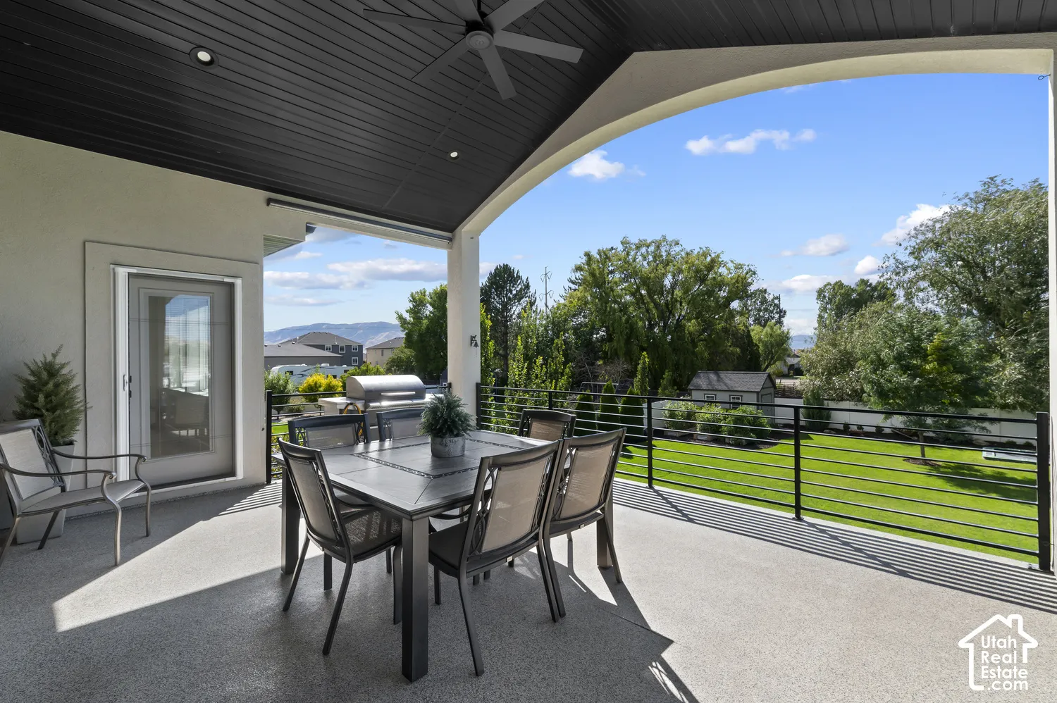 Covered outdoor patio featuring a ceiling fan, recessed lighting, and a glass-paneled door