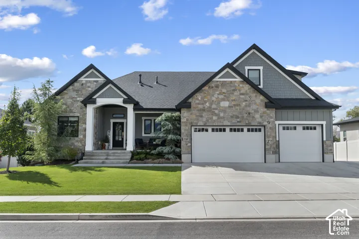 Stone and siding exterior with dark trim accents