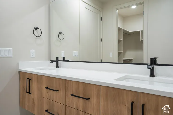 Dual vanity with white solid surface countertop and undermount sinks