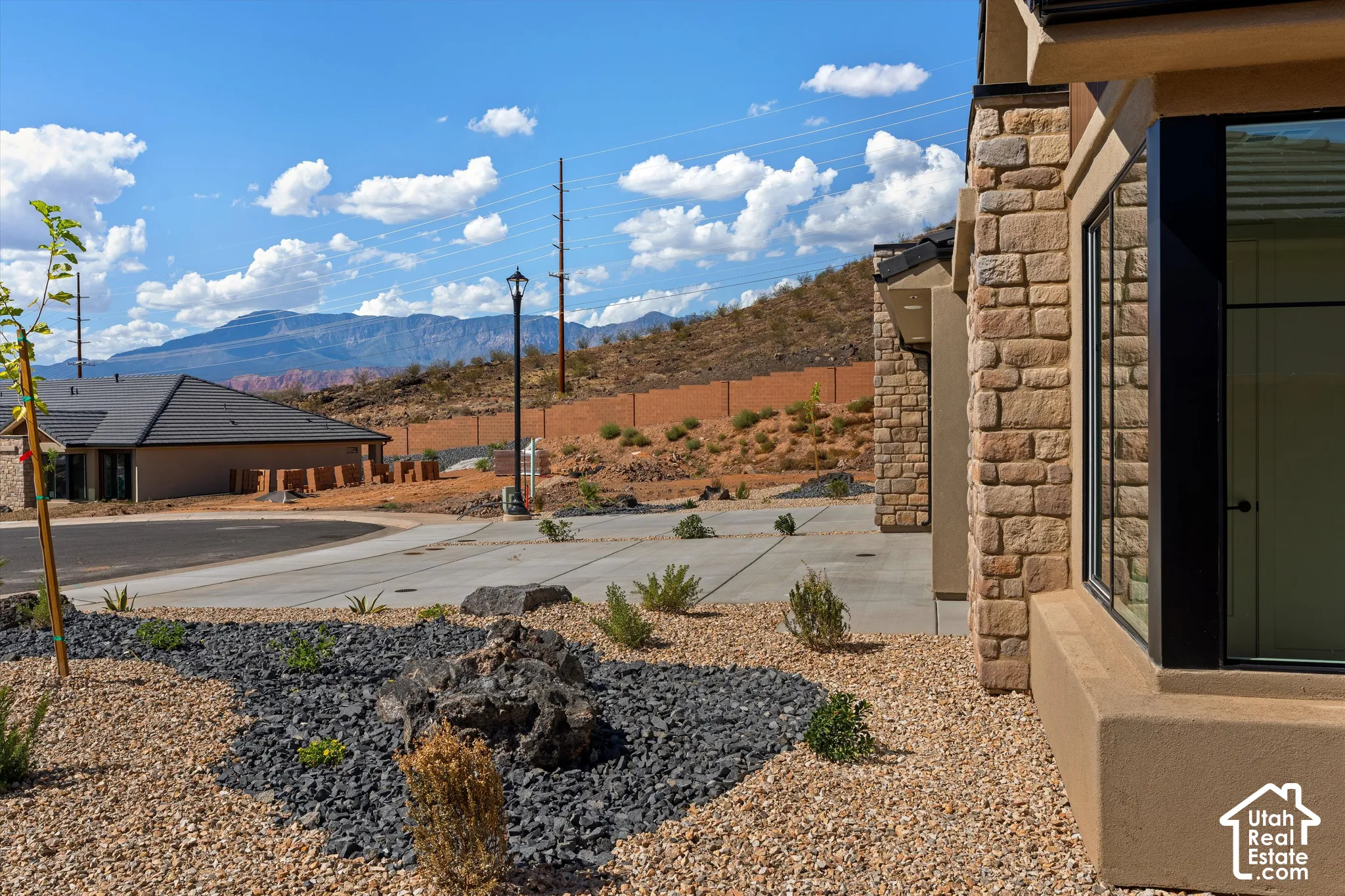 Stone exterior with stucco accents and dark-framed windows