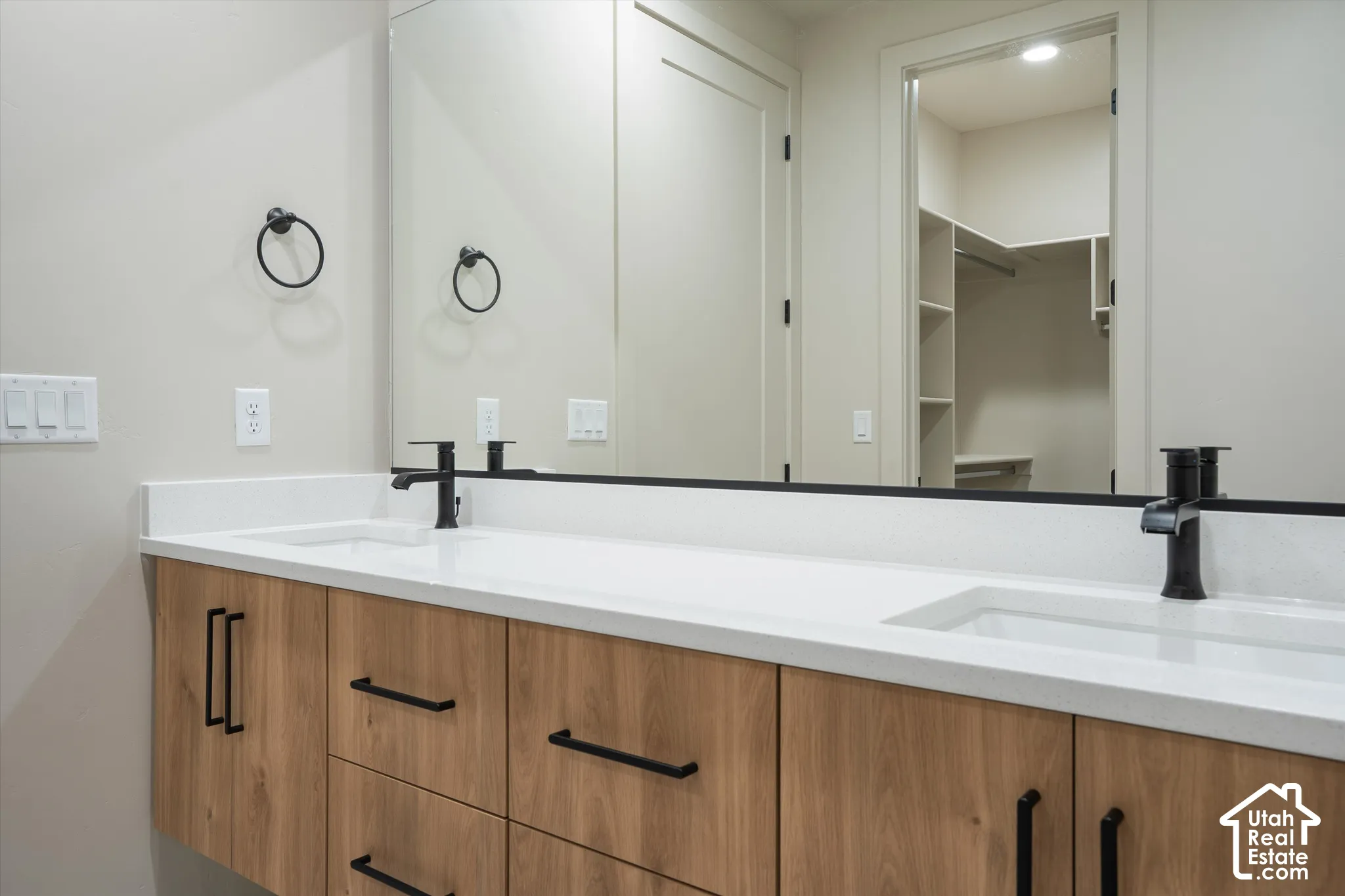 Dual vanity with white solid surface countertop and undermount sinks