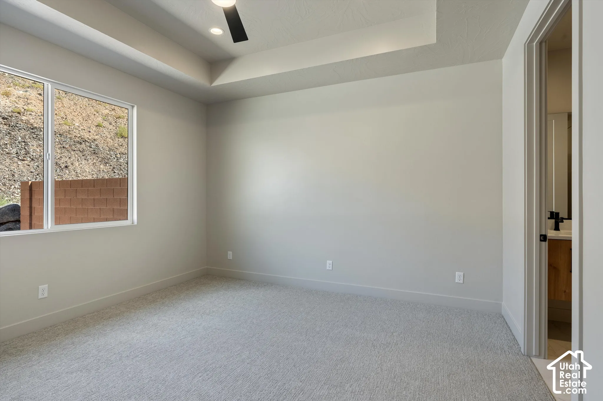 Tray ceiling with recessed lighting and a ceiling fan