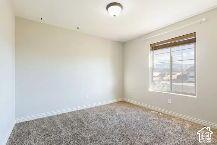 Light-colored wall paint with textured carpeting