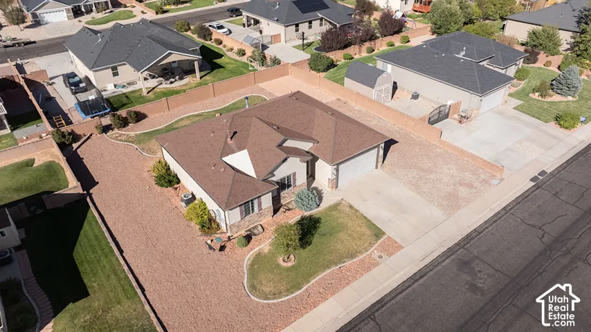 Single-story residence with an attached two-car garage, durable roofing, and a gravel-paved driveway