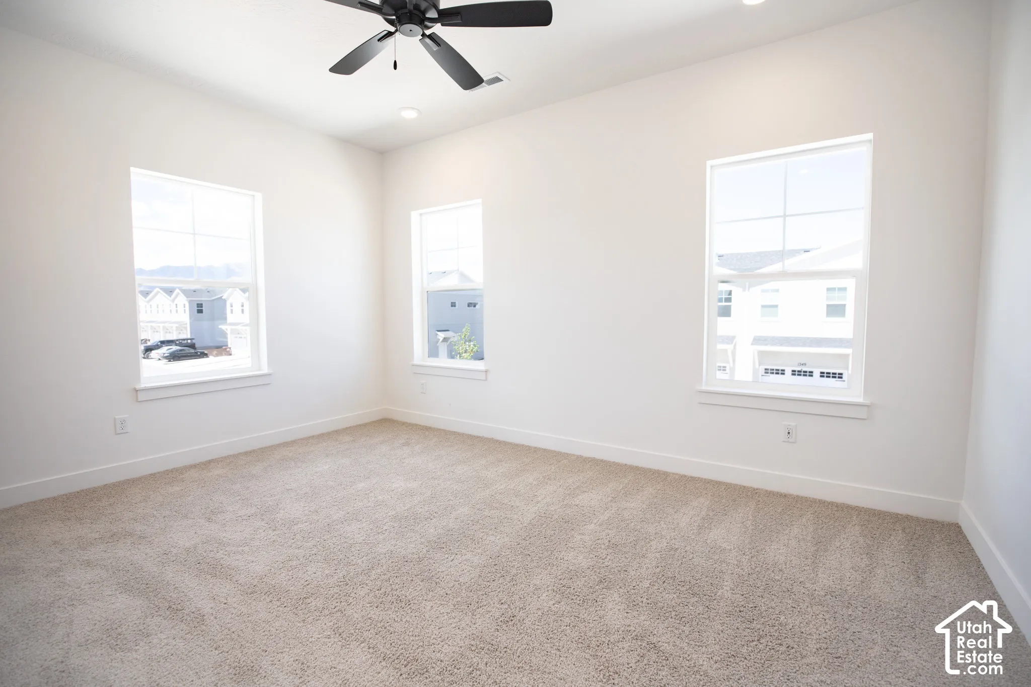 Primary bedroom with 9' ceiling and ceiling fan.