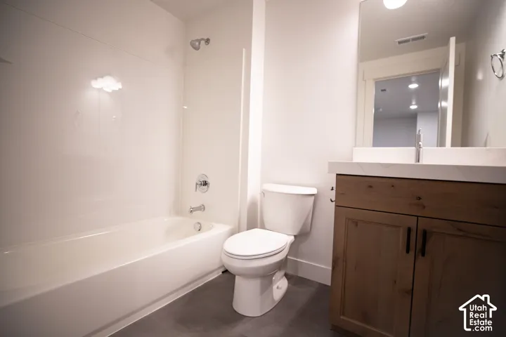 Third full bath with stained wood cabinet and quartz slab countertops as part of fully-finished basement.