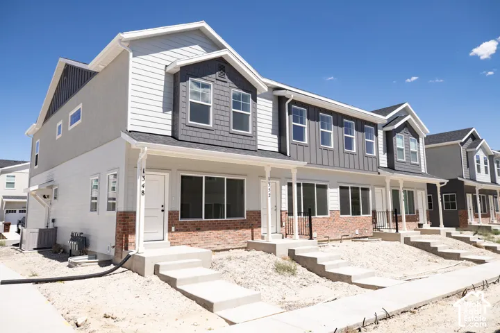 Front view of townhouse building with front yard landscaping to be installed.