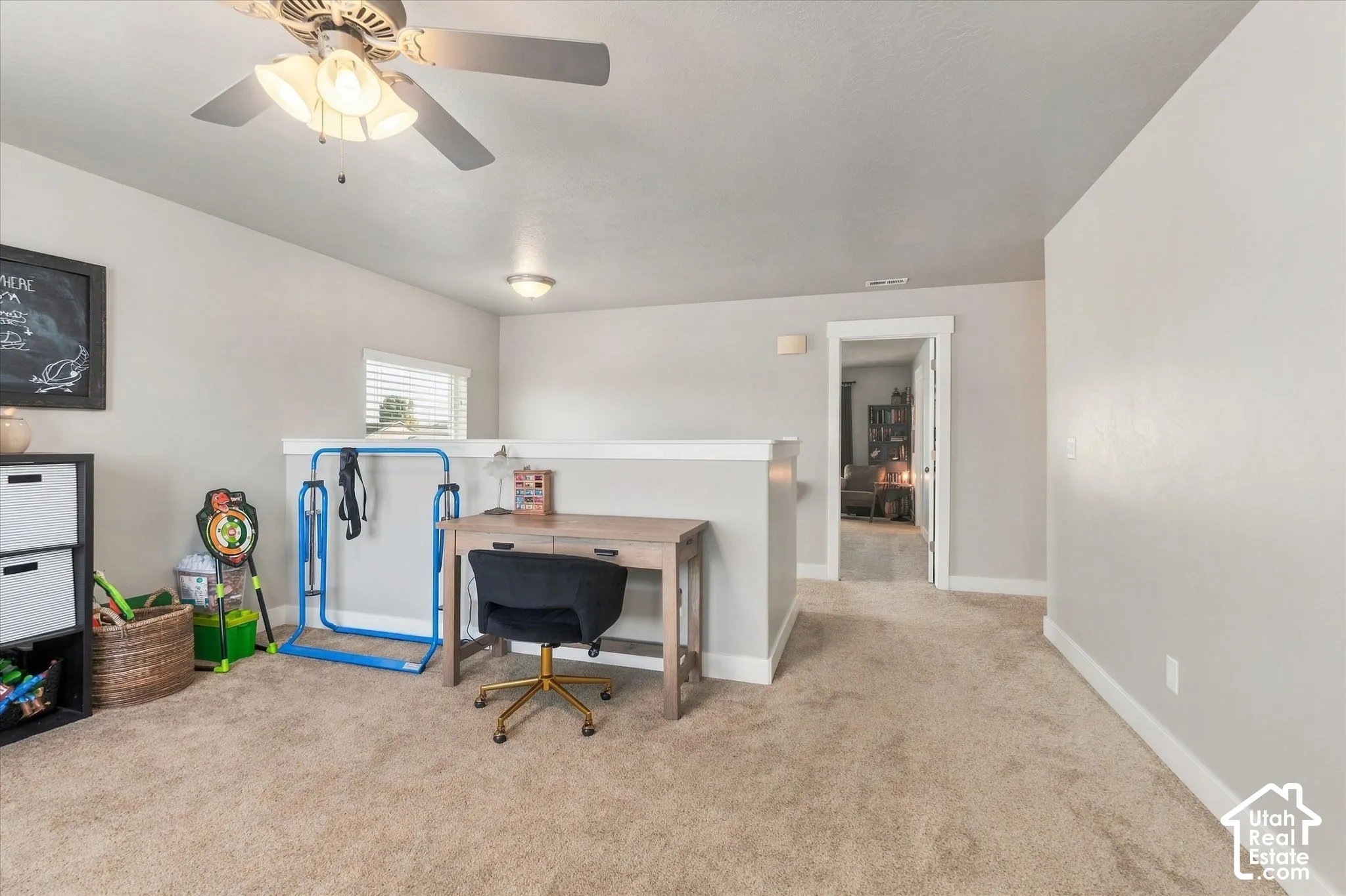 Carpeted loft area featuring a ceiling fan with light, recessed lighting, and a window with blinds