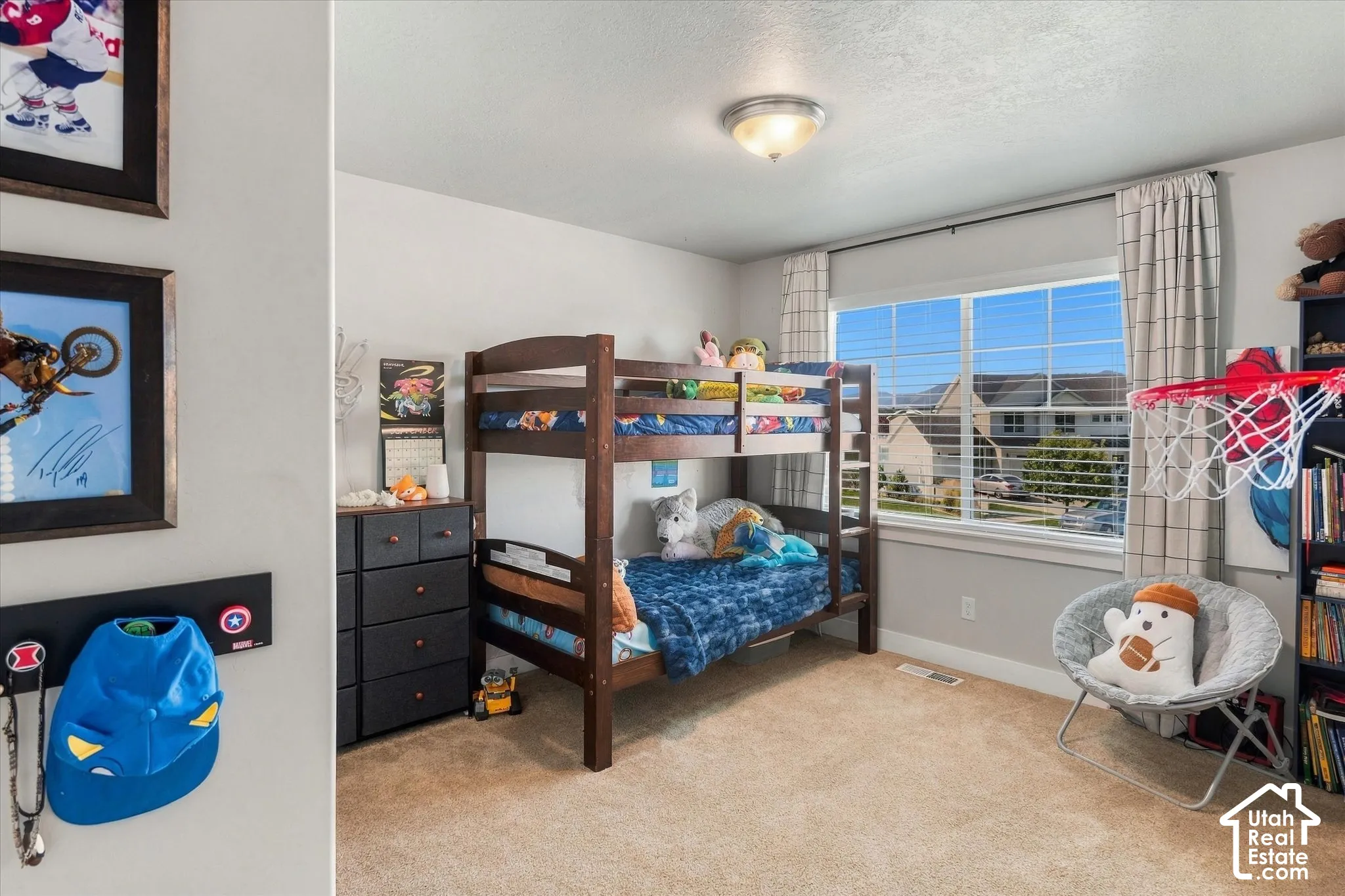 Neutral wall colors, carpeted flooring, and a window with blinds