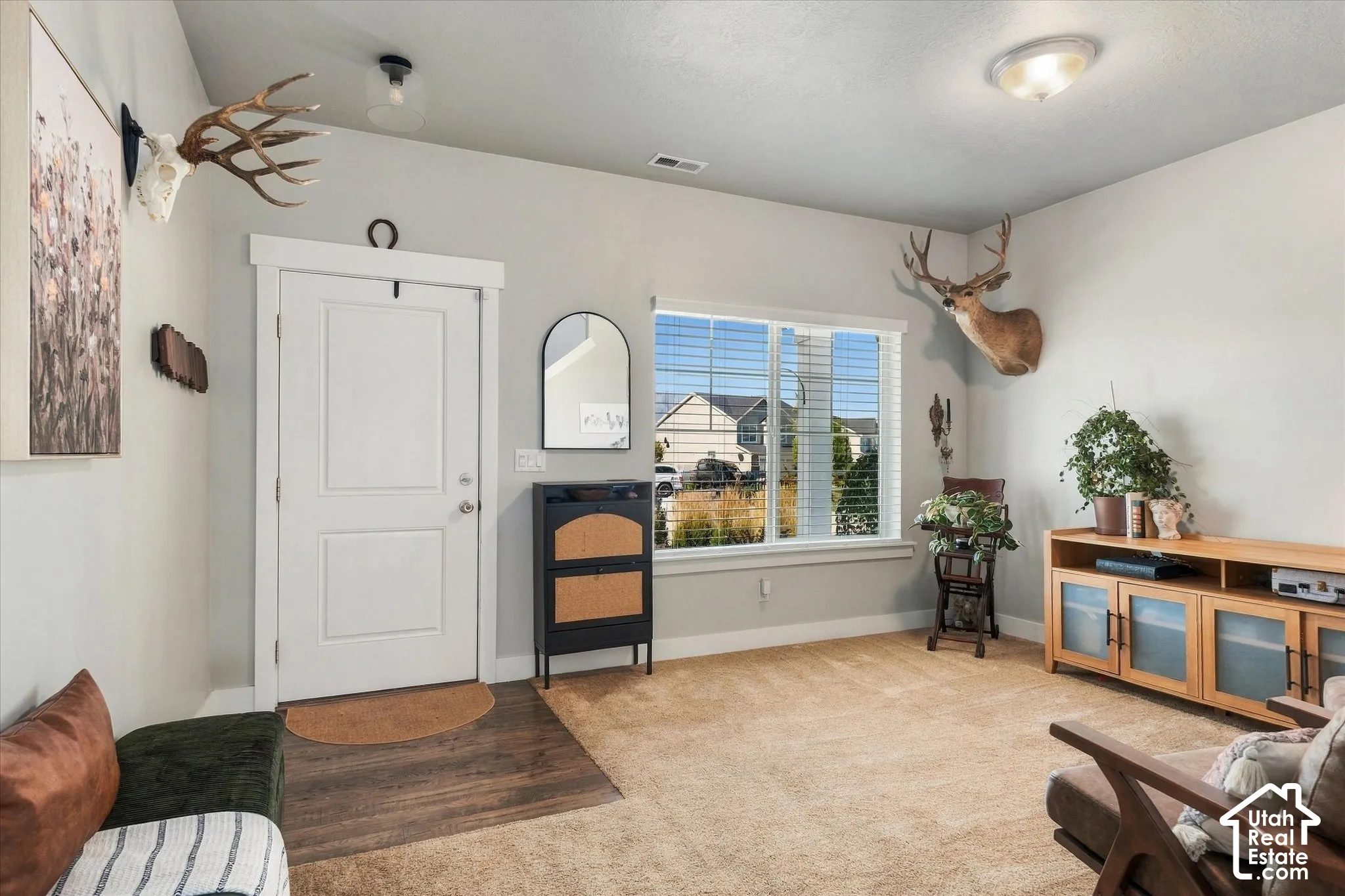 Entryway featuring wood-finish flooring, a white paneled door, and a transom window