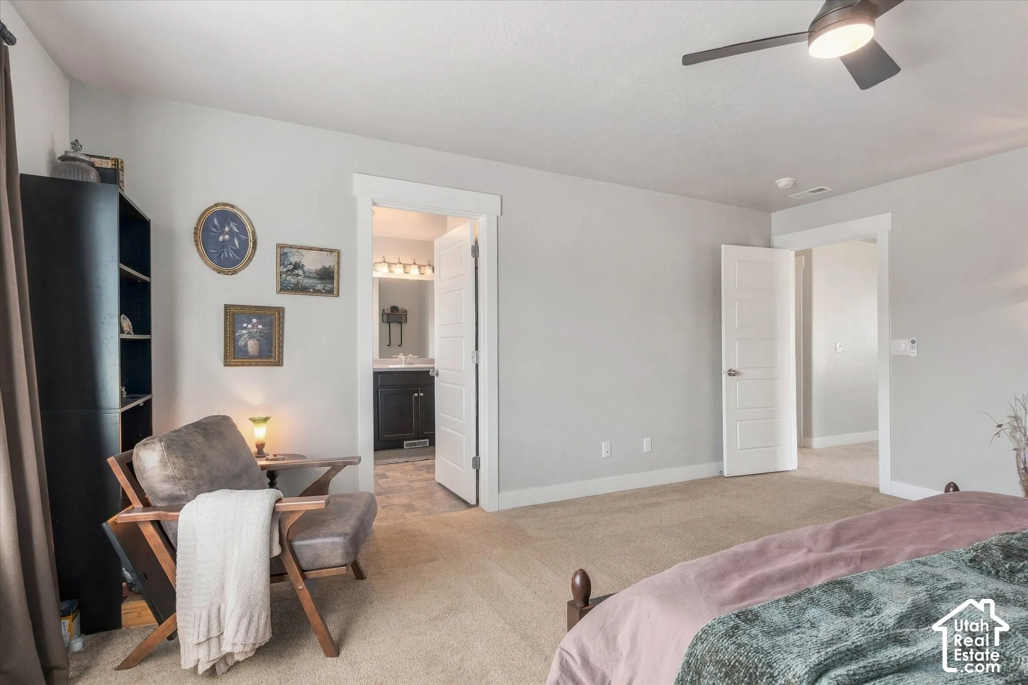 Light-colored carpeting with a ceiling fan overhead