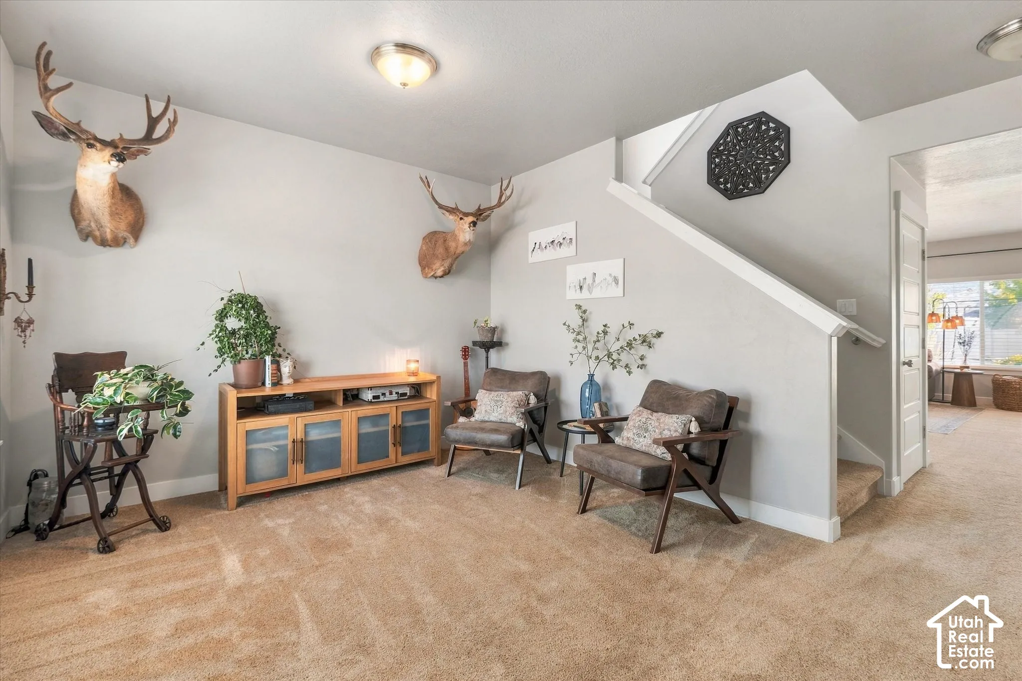 Carpeted flooring extending to a carpeted staircase, light-toned wall paint, and recessed ceiling lighting
