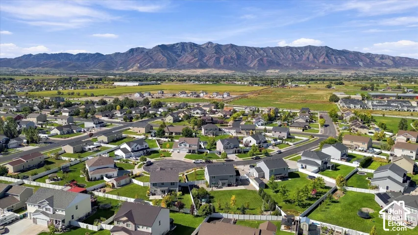 Mountain backdrop with residential properties and expansive green spaces