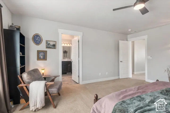 Light-colored carpeting with a ceiling fan overhead