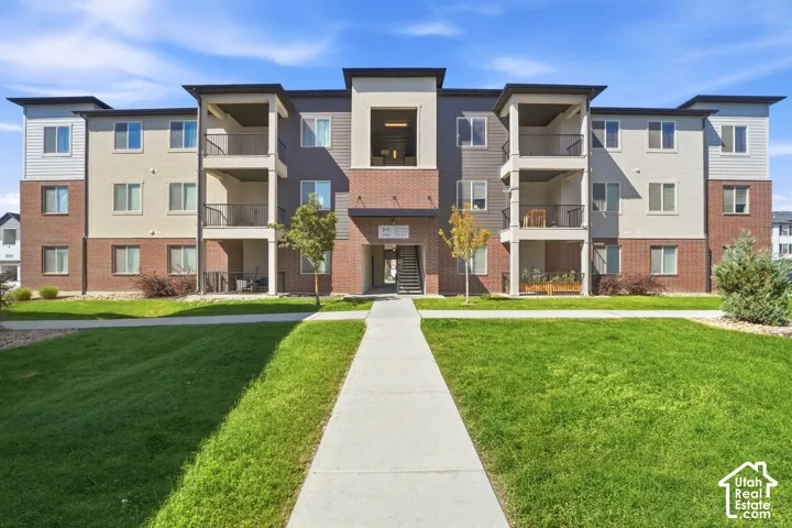 Multi-story exterior featuring brick and siding accents