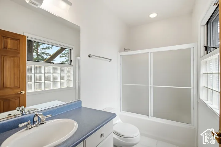 Vanity with a blue countertop, white oval sink, and chrome fixtures