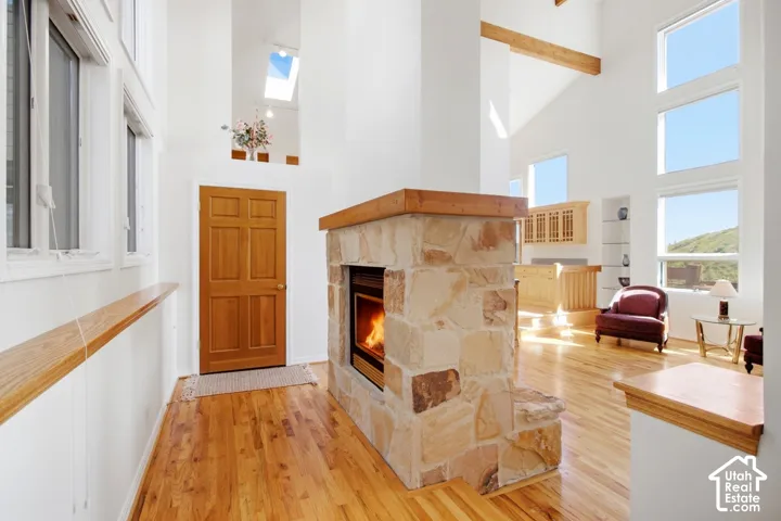 Stacked stone fireplace with a wood mantle