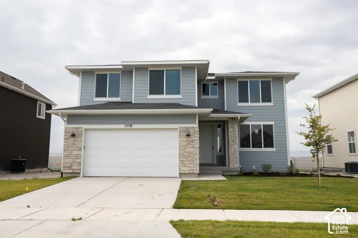 Juniper Elevation B with front yard landscaping installed and decorative concrete wall on back boundary.