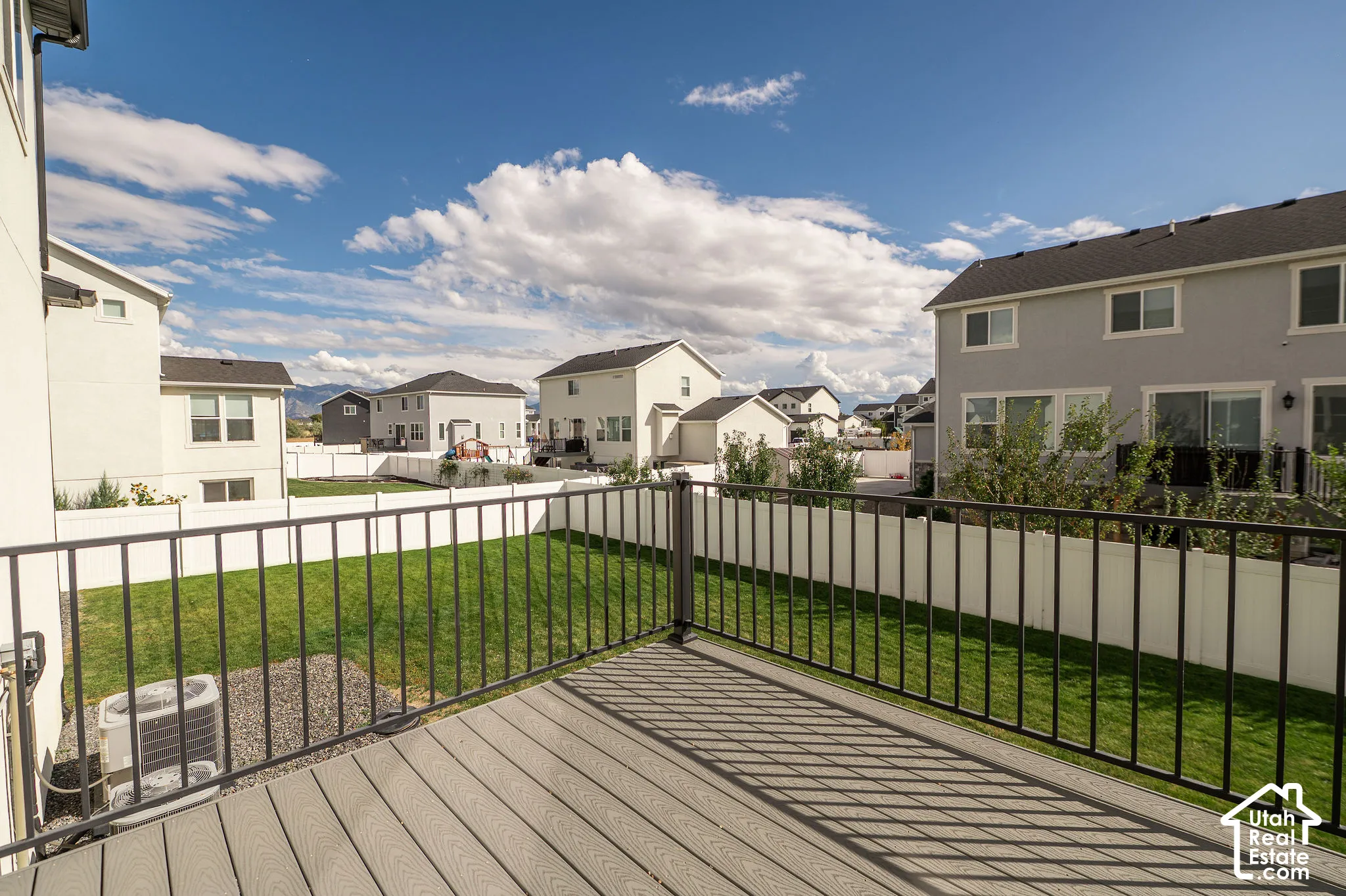 Private deck with composite decking and black metal railings