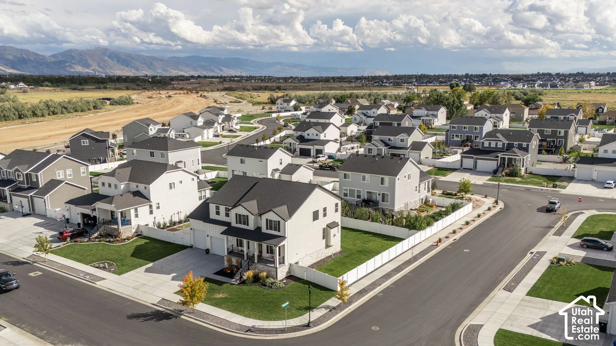 Residential neighborhood featuring detached homes with dark shingle roofs and light-colored siding