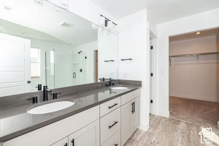 Dual vanity with a dark countertop and matte black fixtures in master