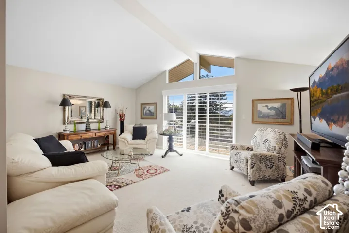 4685 Living room with vaulted ceilings and sliders to balcony