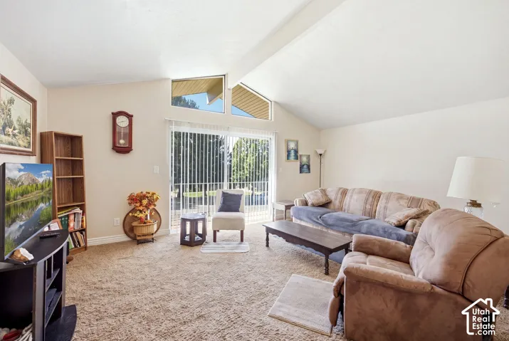4687 Living room with vaulted ceilings and sliders to balcony