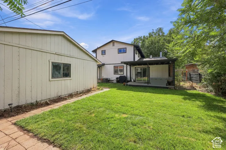 Expansive green lawn with a brick pathway