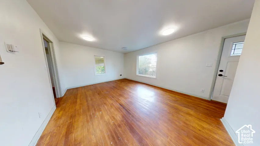 Wood-finish flooring with white walls and trim