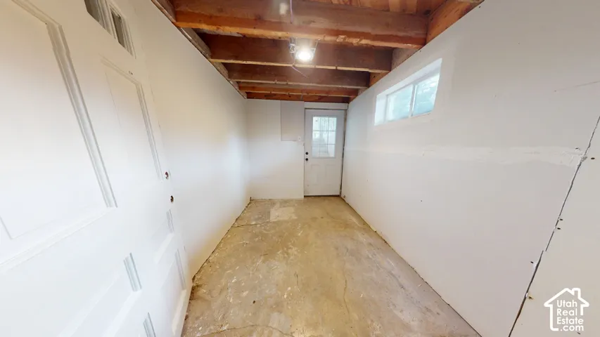 Exposed wood beam ceiling with recessed lighting exterior enterance to basement