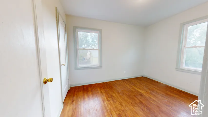 Warm wood-finish flooring with crisp white walls